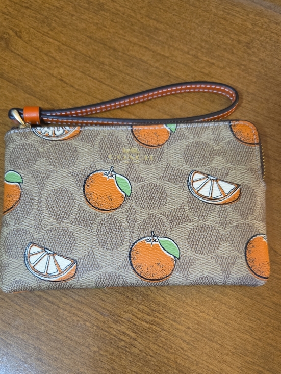 Coach Handbags - Coach Corner Zip Wristlet In Signature Canvas With Orange Print